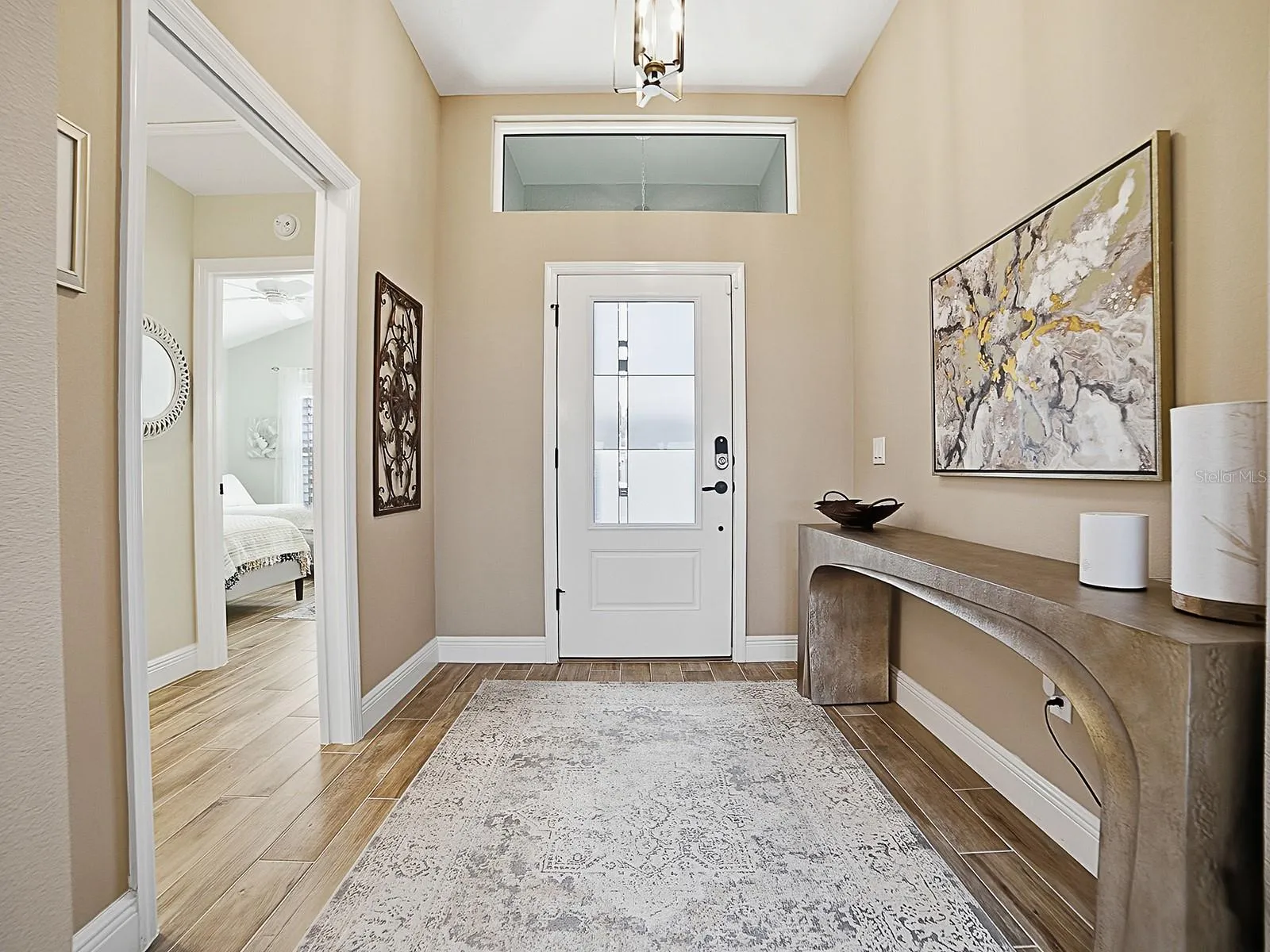 WOOD-LOOK PORCELAIN TILE FLOWS THROUGHOUT THE HOME! NICE LARGE FOYER WITH A POCKET DOOR THAT LEADS TO ONE OF THE GUEST SUITES.