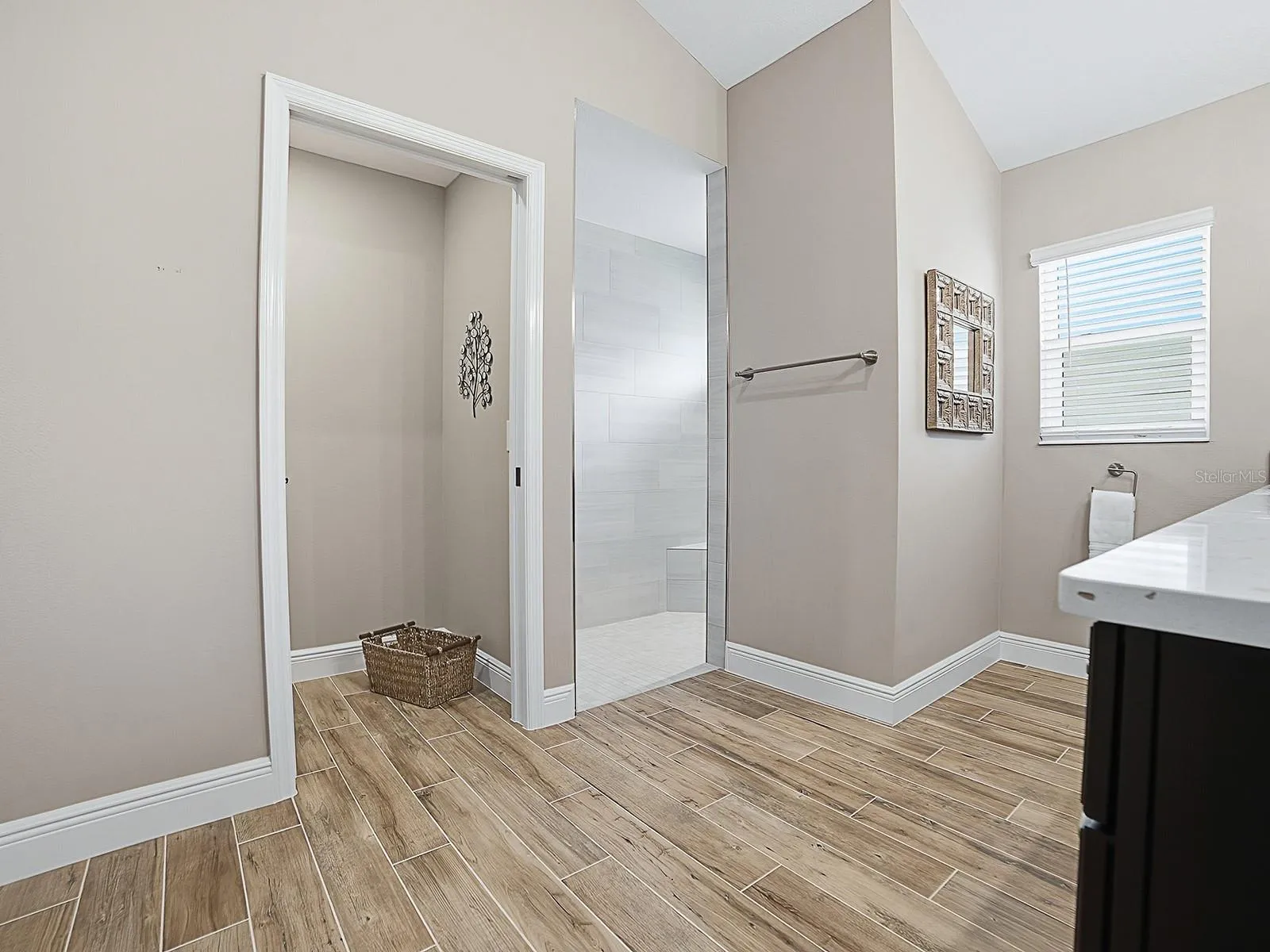 POCKET DOOR TO THE PRIVATE TOILET ROOM AND ROMAN WALK-IN SHOWER TO THE RIGHT.