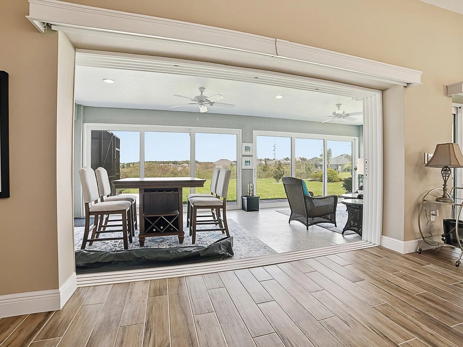 THE SLIDING GLASS DOORS HAVE REMOTE CONTROL PANEL TRACK BLINDS.