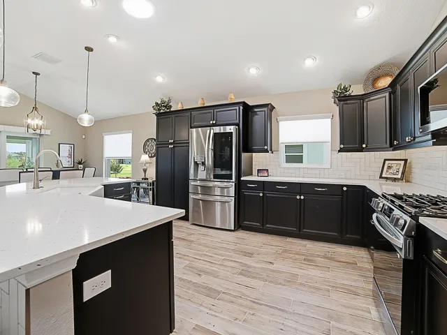 WHAT A BEAUTIFUL KITCHEN! QUARTZ COUNTERTOPS, STAINLESS APPLIANCES, CUSTOM CHAMPAGNE BRONZE HARDWARE, UPPER AND LOWER PULL OUT DRAWERS IN LOWER CABINETS.