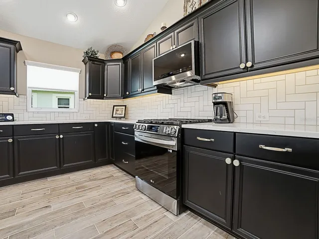 LOVELY TILE BACKSPLASH WITH UNDER CABINET LIGHTING!