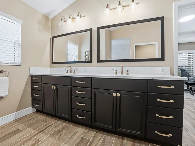 QUARTZ COUNTERTOPS, DUAL SINKS, SAME LOVELY HARDWARE THROUGHOUT THE HOME, AND CUSTOM FRAMED MIRRORS.