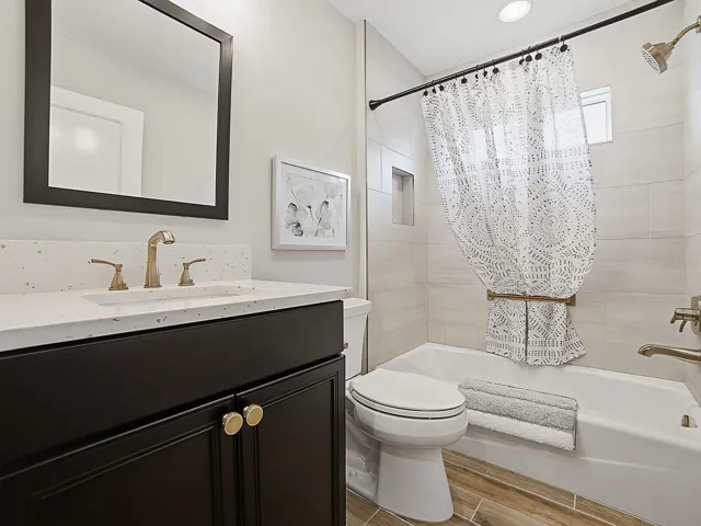 2ND GUEST BATH WITH QUARTZ COUNTERTOPS AND TUB/SHOWER.