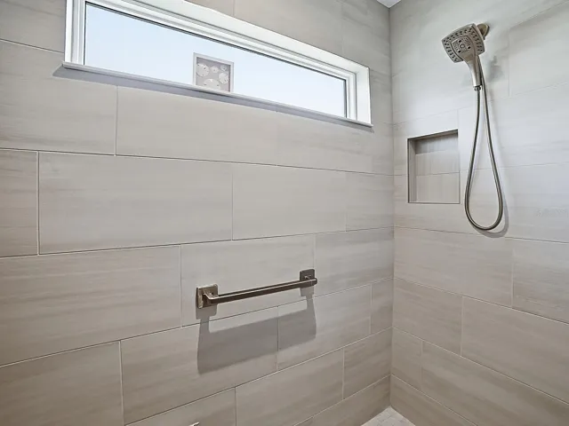 LOVELY TILED SHOWER WITH A WINDOW.