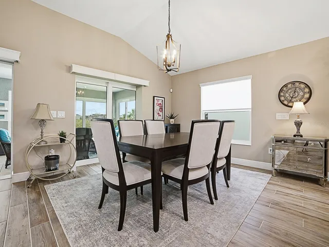 LIGHT AND BRIGHT WITH THE LARGE WINDOW AND STACKBACK SLIDING GLASS DOORS THAT OPEN TO THE FLORIDA ROOM OFFERING A GREAT VIEW OF THE PRESERVE.
