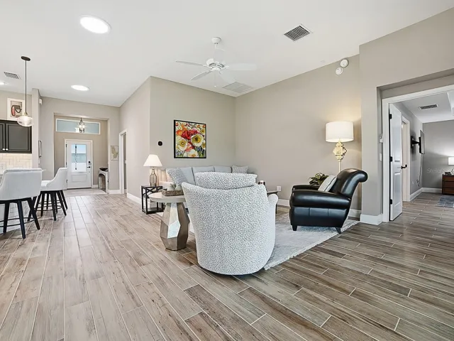 OPEN FLOOR PLAN WITH SOLAR TUBES THROUGHOUT THE HOME FOR NATURAL LIGHTING.  THE POCKET DOOR TO THE RIGHT LEADS TO ANOTHER GUEST SUITE AND LAUNDRY.  THE KITCHEN IS TO THE LEFT.