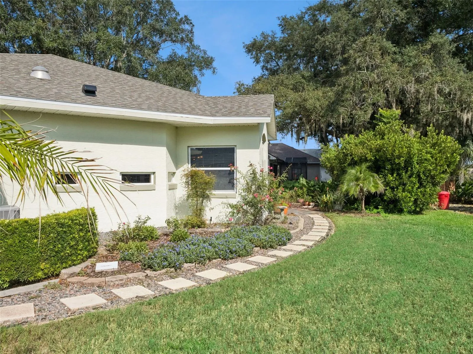 Right side of home leading to backyard patio and garden