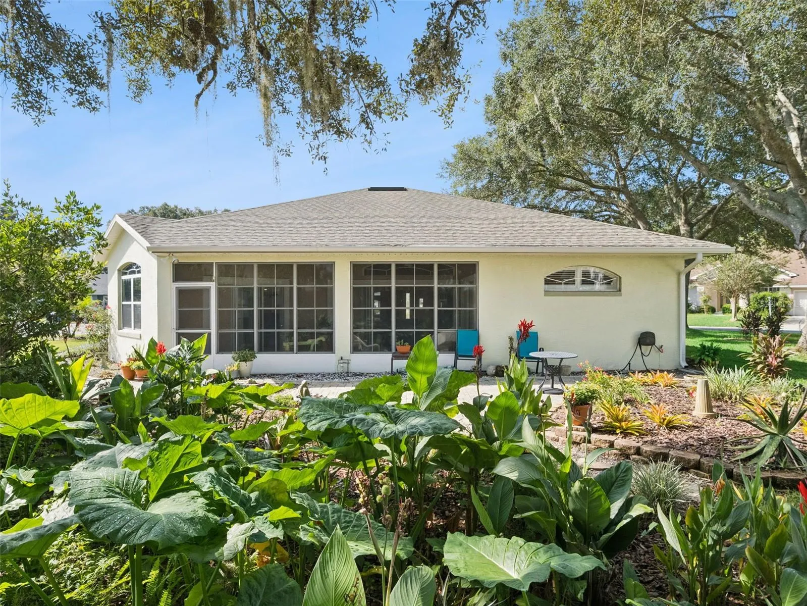 The backyard is adorned with Florida-friendly plantings and a lovely garden walk, plus a spacious patio to sit and enjoy the view.