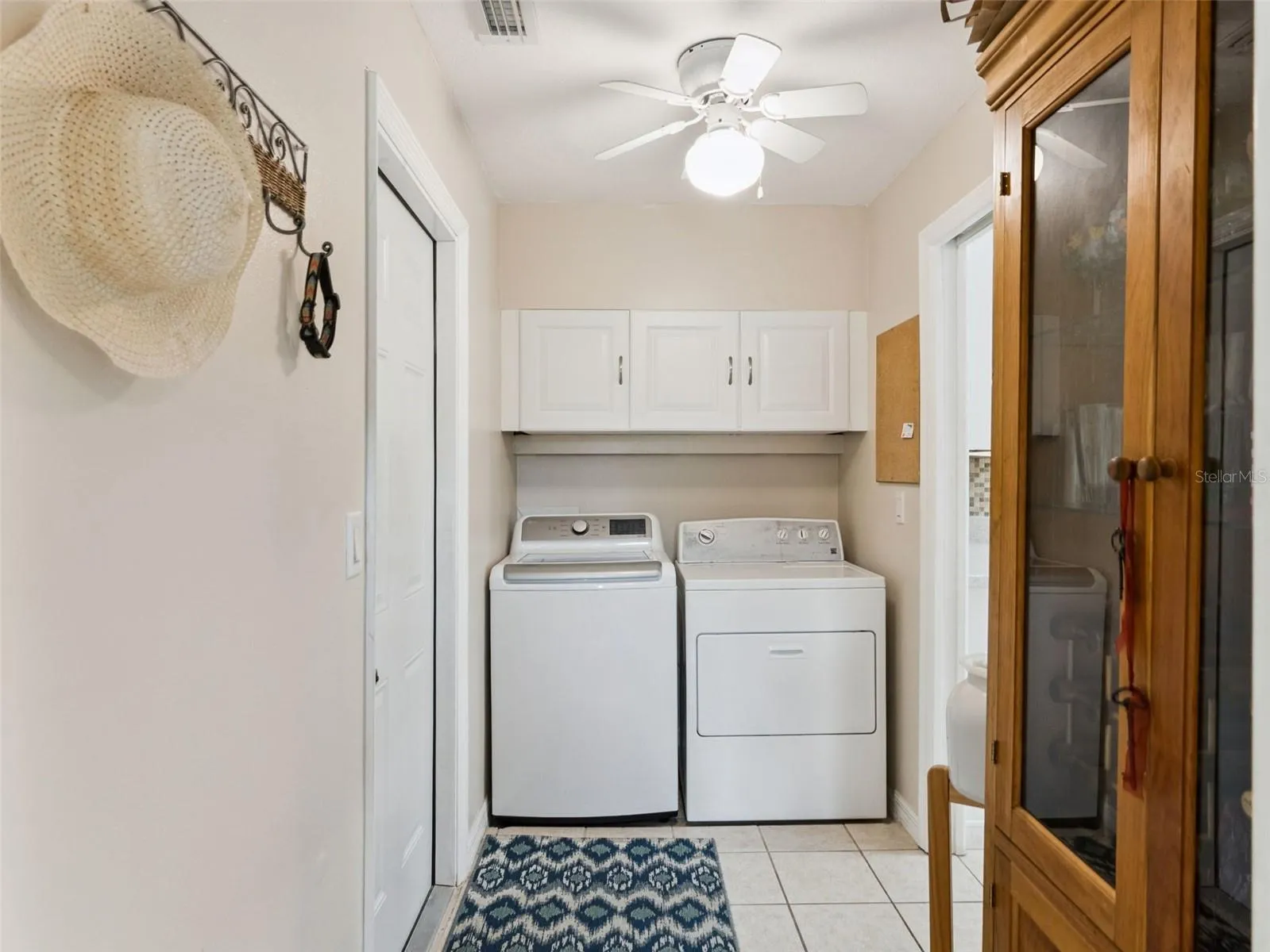 The Laundry/Mud room has upper cabinets for storage.