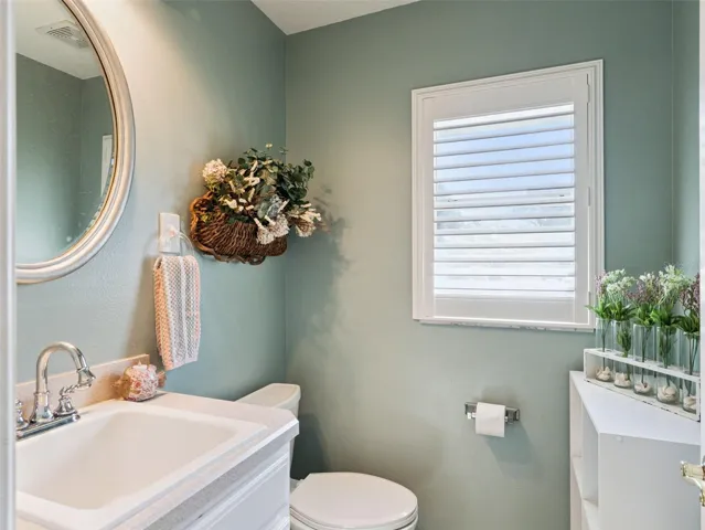 This convenient Powder Room is just off the Laundry/Mud Room for easy access from outside the house.