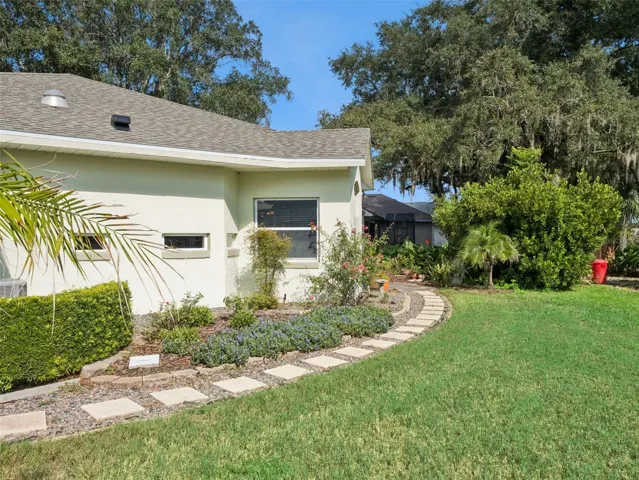 Right side of home leading to backyard patio and garden
