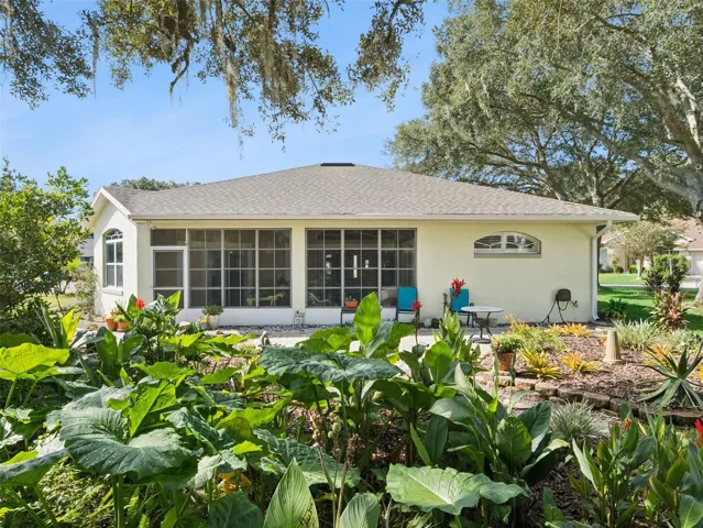 The backyard is adorned with Florida-friendly plantings and a lovely garden walk, plus a spacious patio to sit and enjoy the view.