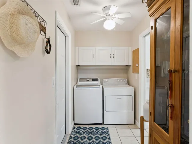 The Laundry/Mud room has upper cabinets for storage.