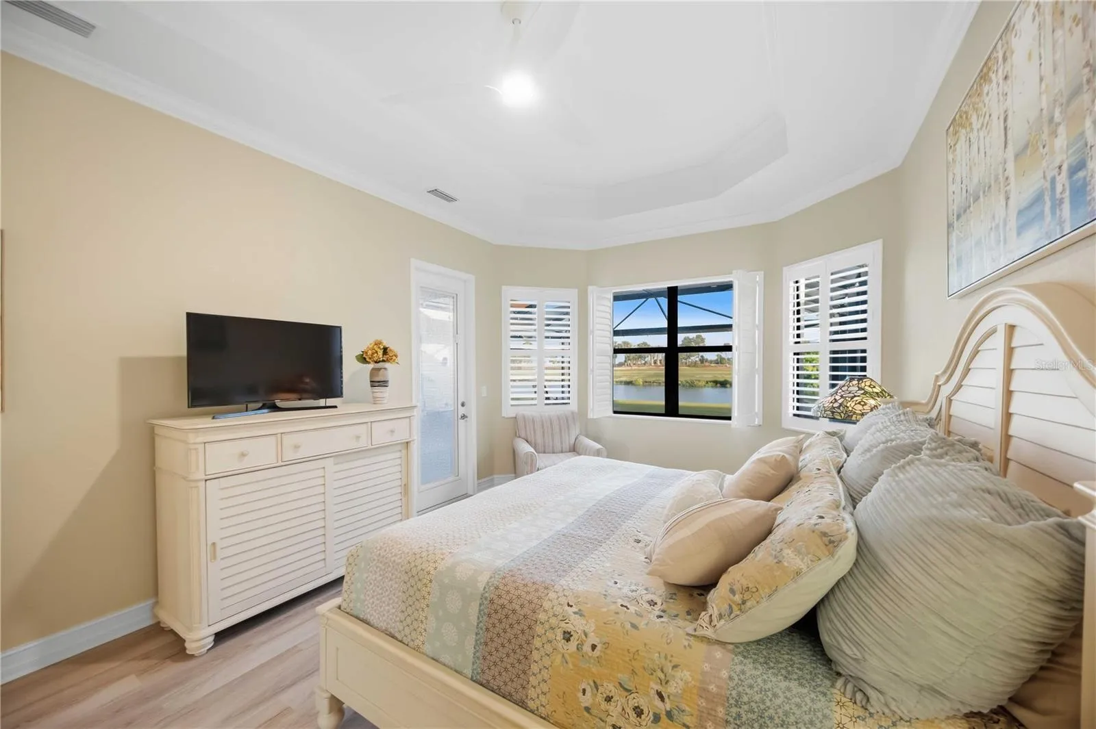 Primary Bedroom with entry to the lanai overlookiing the pool/spa