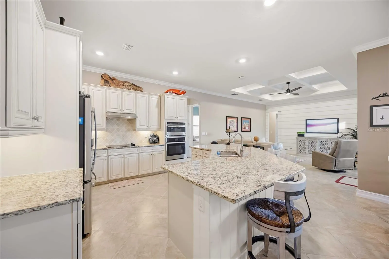 Upscale Kitchen with double ovens, dishwasher, cooktop, plenty of counter space, and dining on the counter.