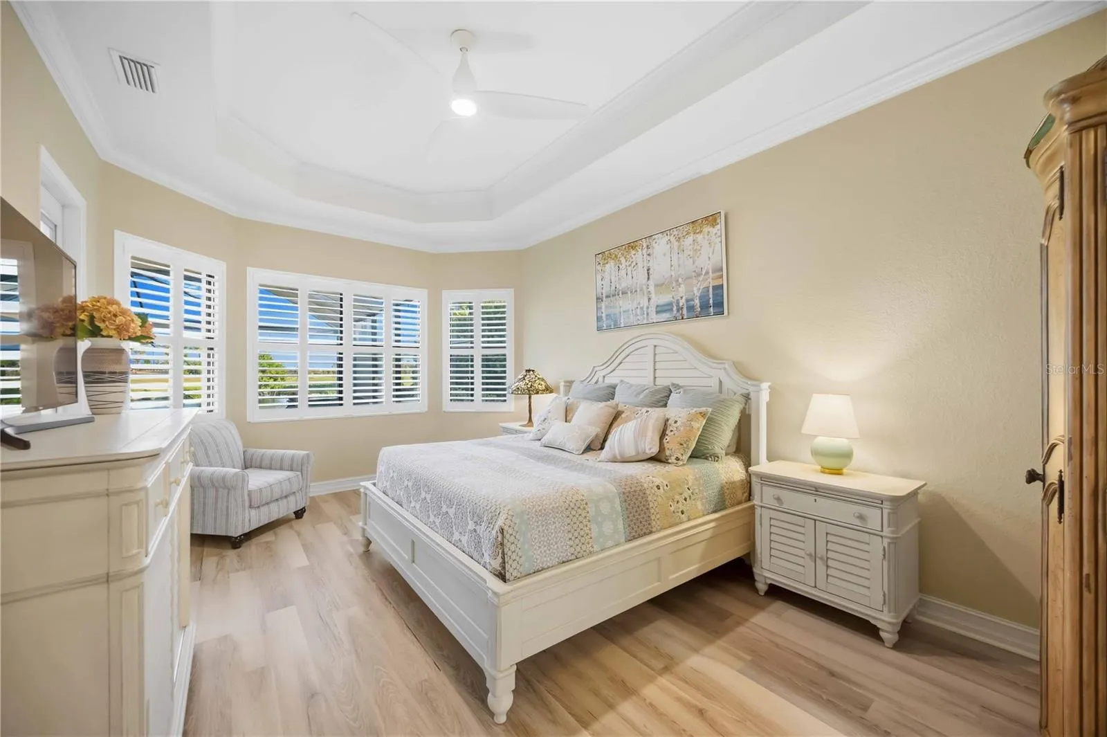 Primary Bedroom with entry to the lanai overlookiing the pool/spa
