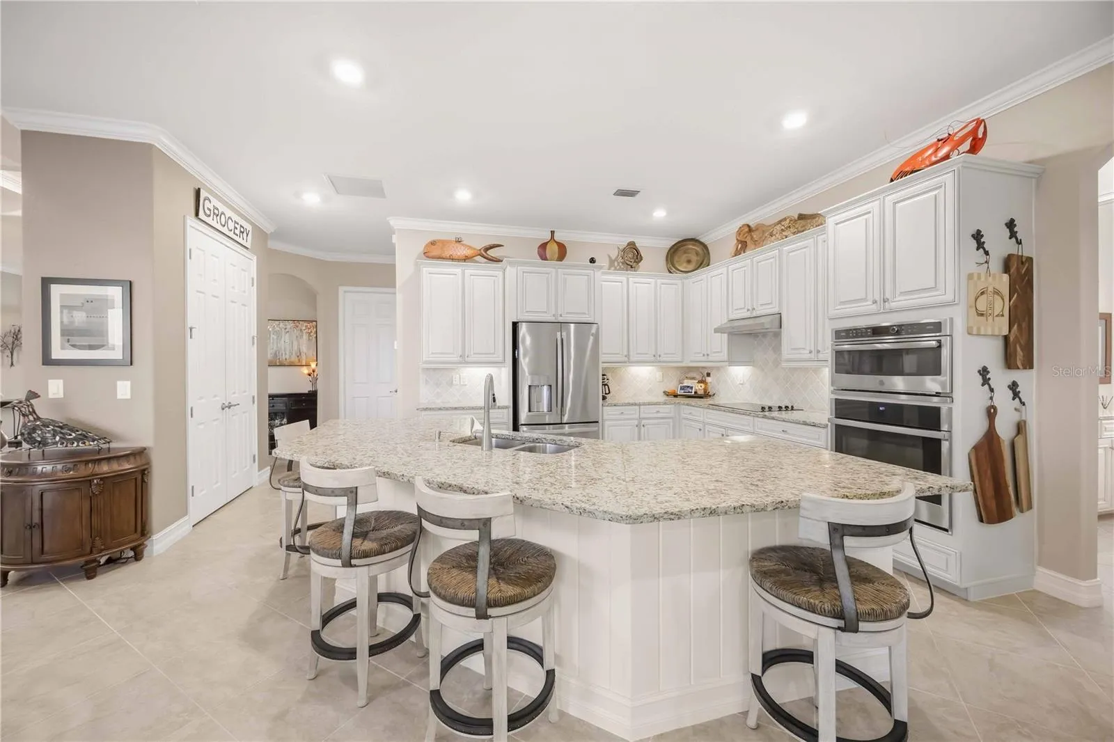 Upscale Kitchen with double ovens, dishwasher, cooktop, plenty of counter space, and dining on the counter.