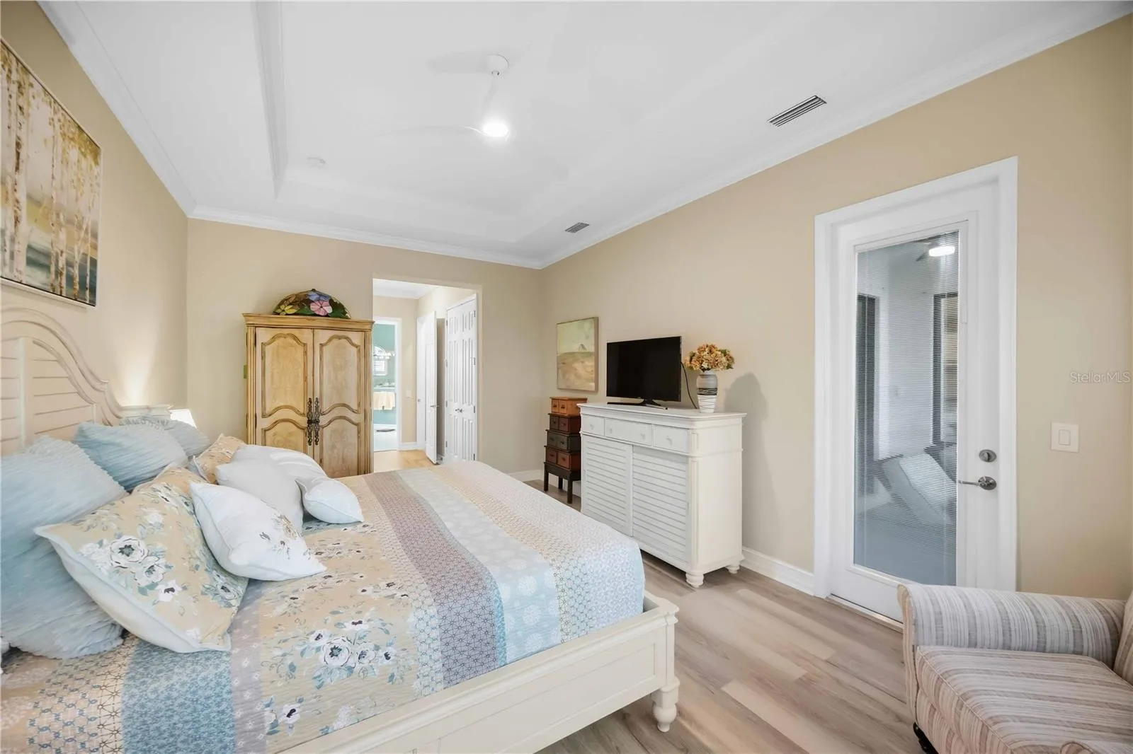 Primary Bedroom with entry to the lanai overlookiing the pool/spa