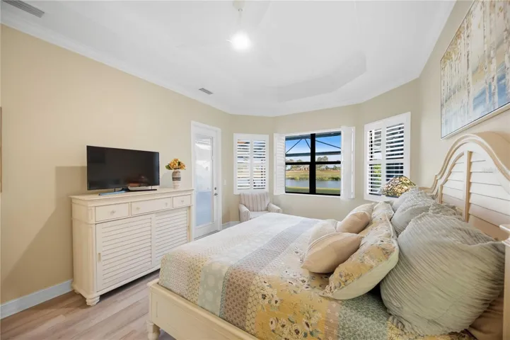 Primary Bedroom with entry to the lanai overlookiing the pool/spa