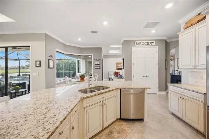 Upscale Kitchen with double ovens, dishwasher, cooktop, plenty of counter space, and dining on the counter.