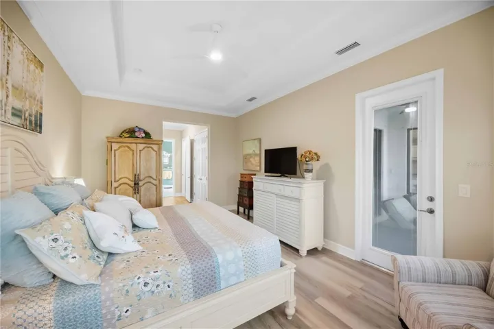 Primary Bedroom with entry to the lanai overlookiing the pool/spa