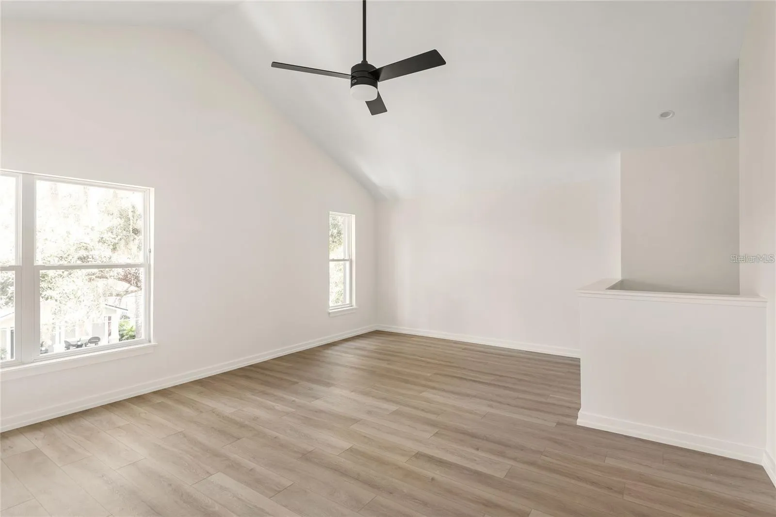 Level Three: Living room featuring Vaulted Ceiling