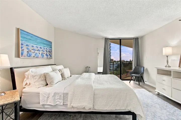 Primary suite with a view and access to balcony