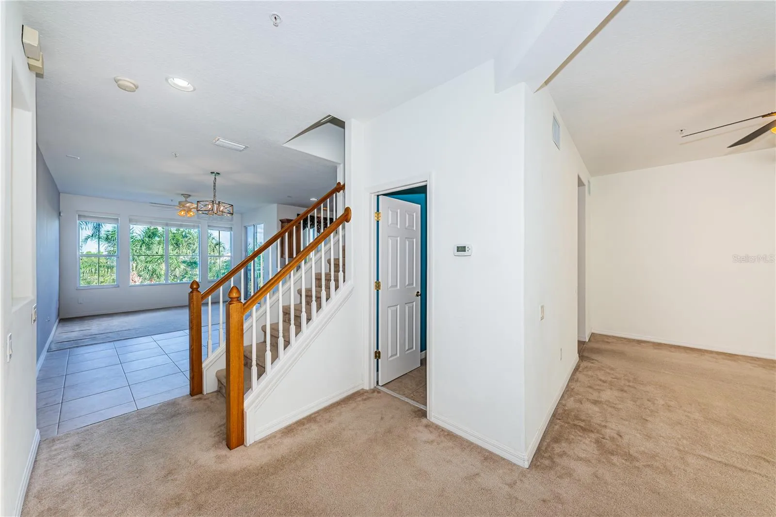 Stairway to bedroom level and a powder room outside the living room