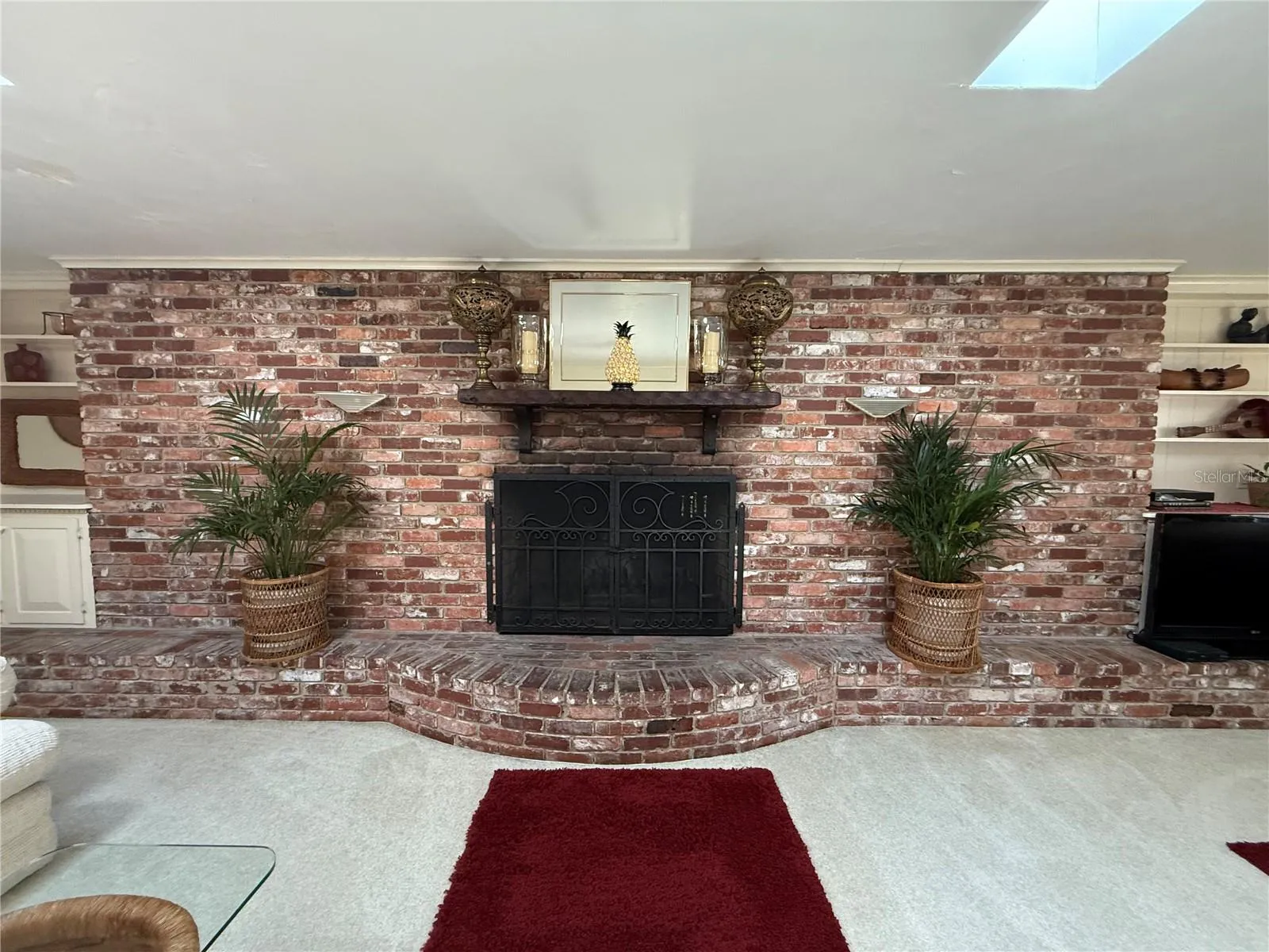 Wod Burning Fireplace encased in brick accent wall
