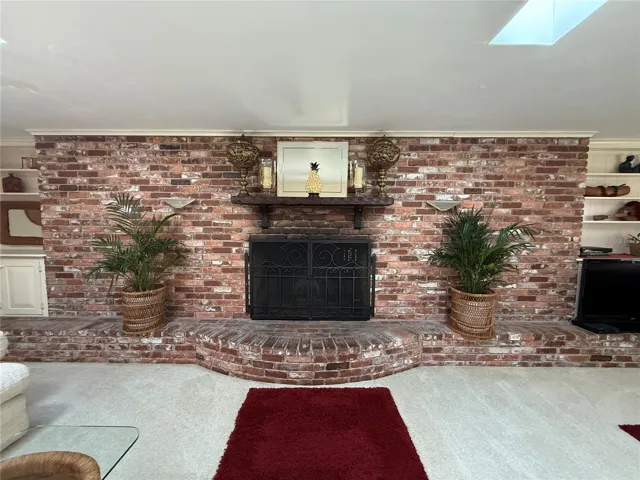 Wod Burning Fireplace encased in brick accent wall