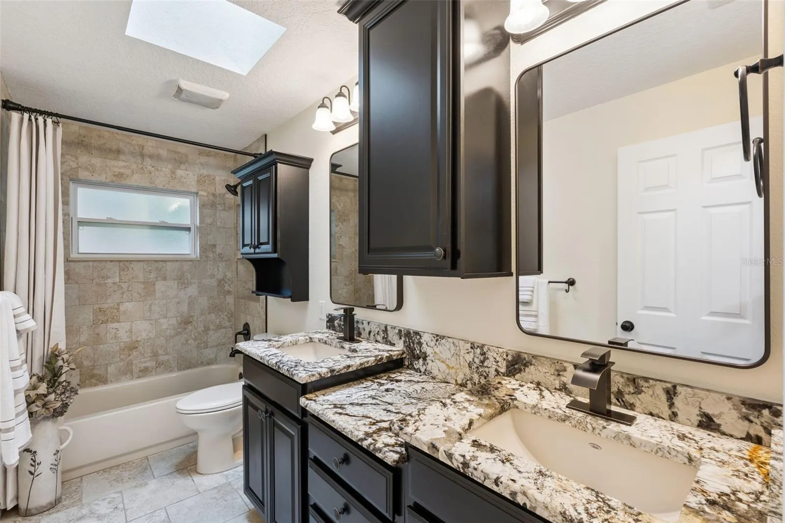 Designer 2nd bath with double sinks and tons of storage.