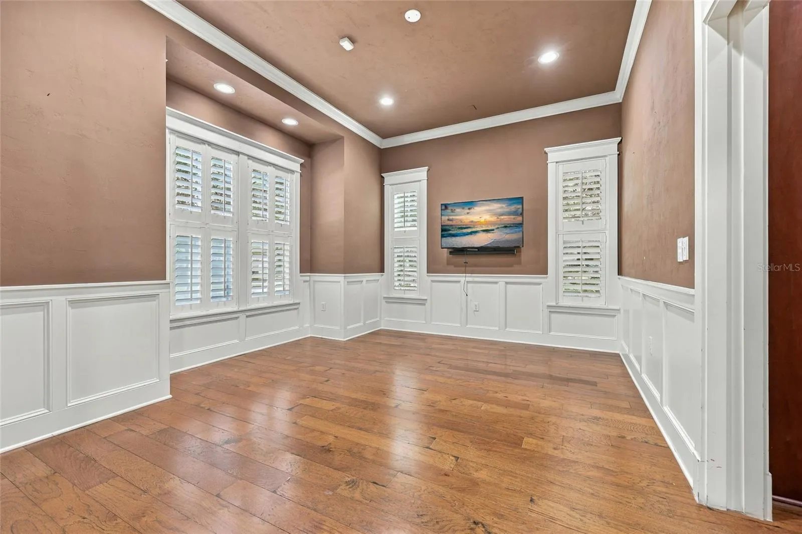 Formal Dining Room with plantation shutters &amp;  custom crown moulding