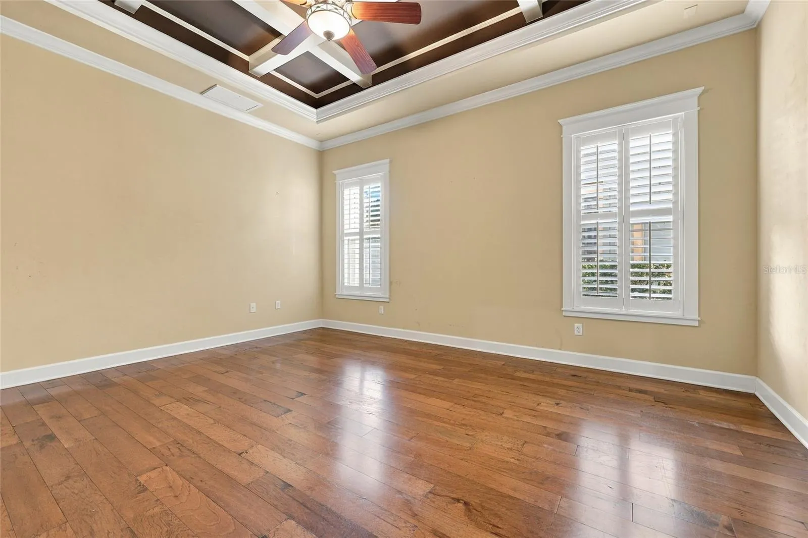 Primary Bedroom Suite with dramatic coffered ceiling feature