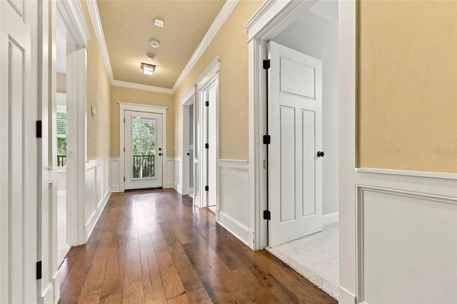 Upstairs hallway to second floor covered porch and three bedrooms.