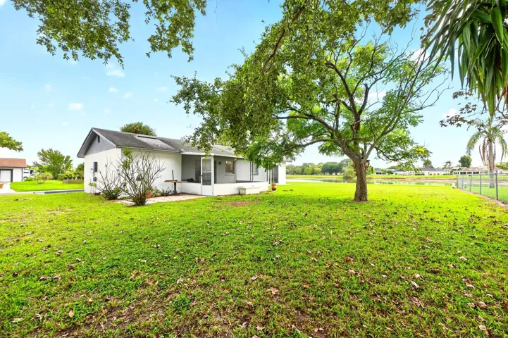 Outside, the GENEROUS YARD offers plenty of room to garden, entertain, or simply enjoy the Florida sunshine.