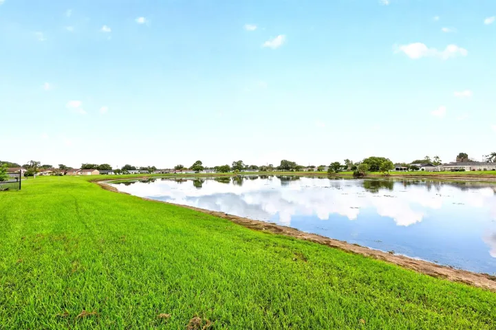 The CORNER-LOT SETTING AND POND VIEW add to the home's sense of space and tranquility.