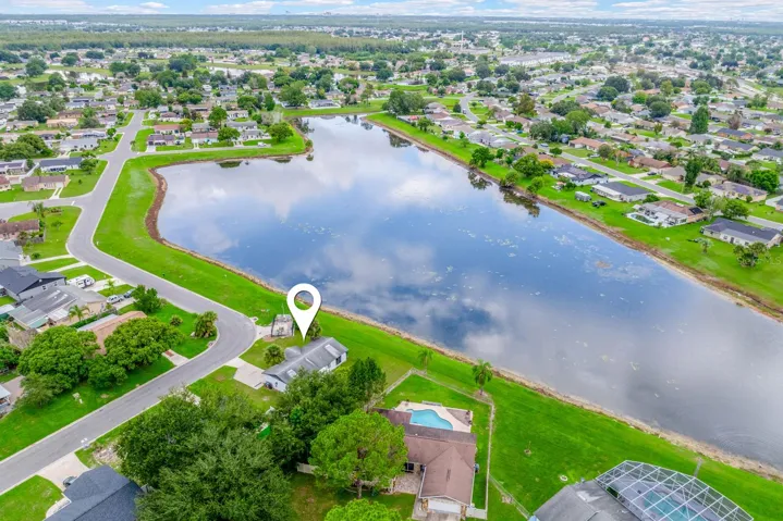 Situated on a CORNER LOT WITH A POND VIEW, the home features a 1-car garage, OVERSIZED DRIVEWAY for additional parking and a spacious yard.