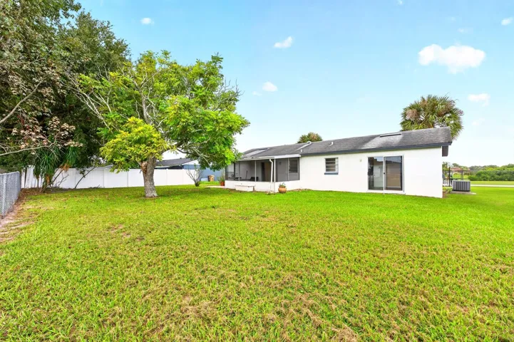 Outside, the GENEROUS YARD offers plenty of room to garden, entertain, or simply enjoy the Florida sunshine.