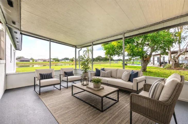 Sliding glass doors open to the SCREENED AND ENCLOSED BACK PORCH, creating a comfortable extension of the living space and an inviting spot to enjoy the peaceful backyard and pond view. Virtually Staged