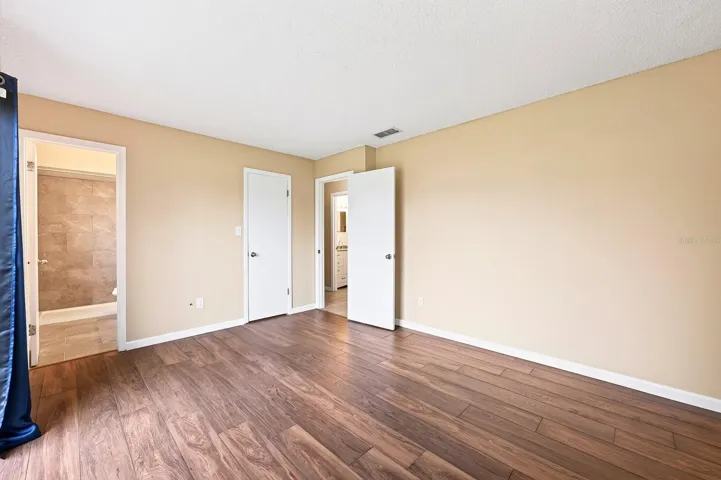 The spacious Primary Bedroom includes sliding glass doors that open directly to the backyard, bringing in plenty of NATURAL LIGHT and creating EASY ACCESS to the outdoor space.
