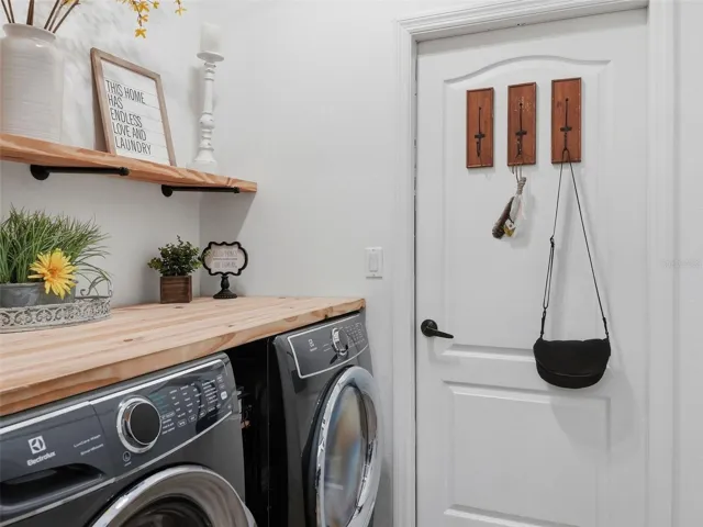 Butcher block counter and shelving in the laundry room.