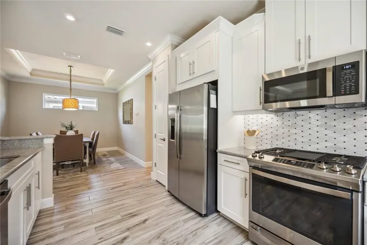 Natural gas range stainless steel appliances; dining room open to kitchen