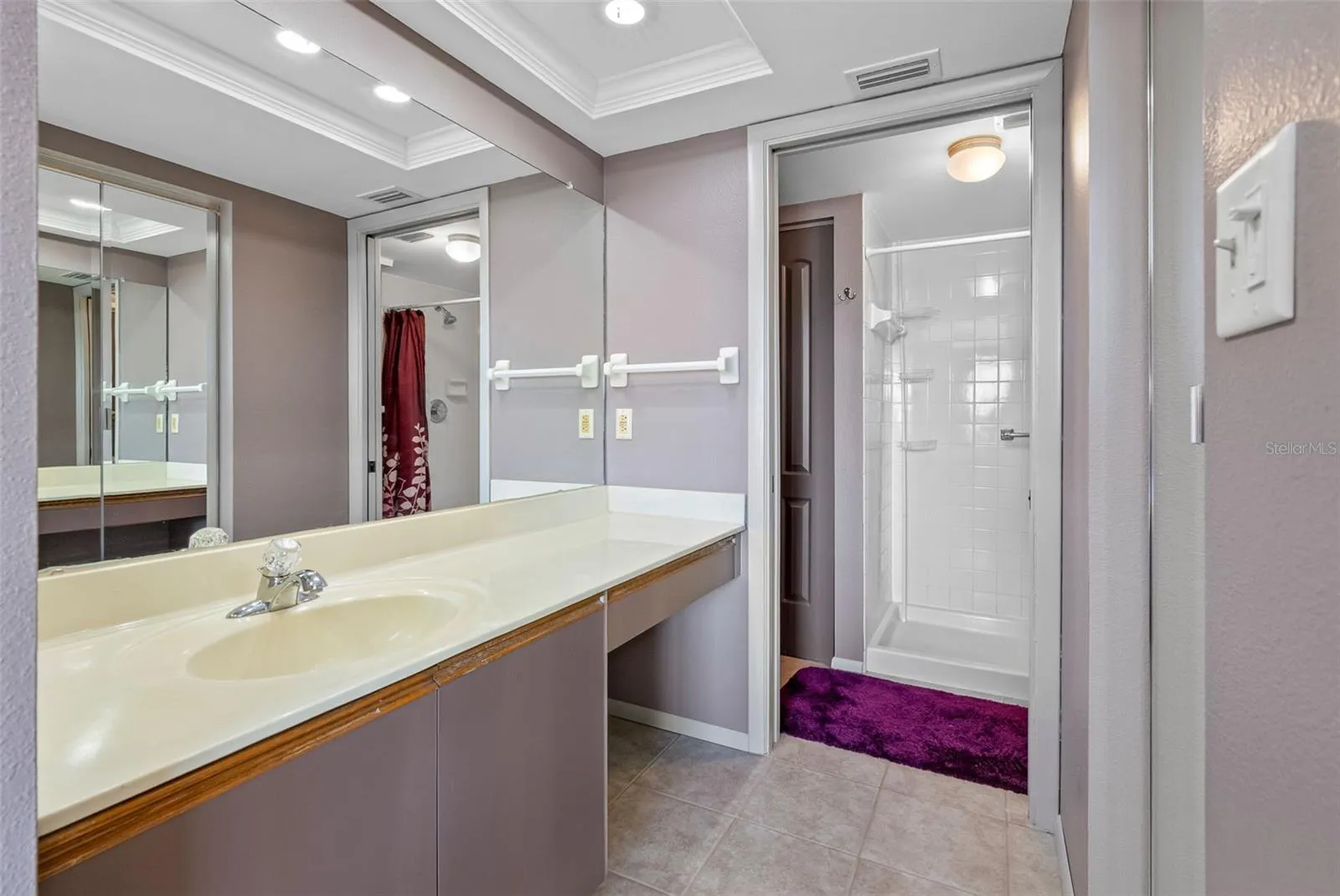 En suite bath with step in shower and walk in closet