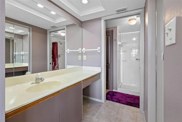 En suite bath with step in shower and walk in closet