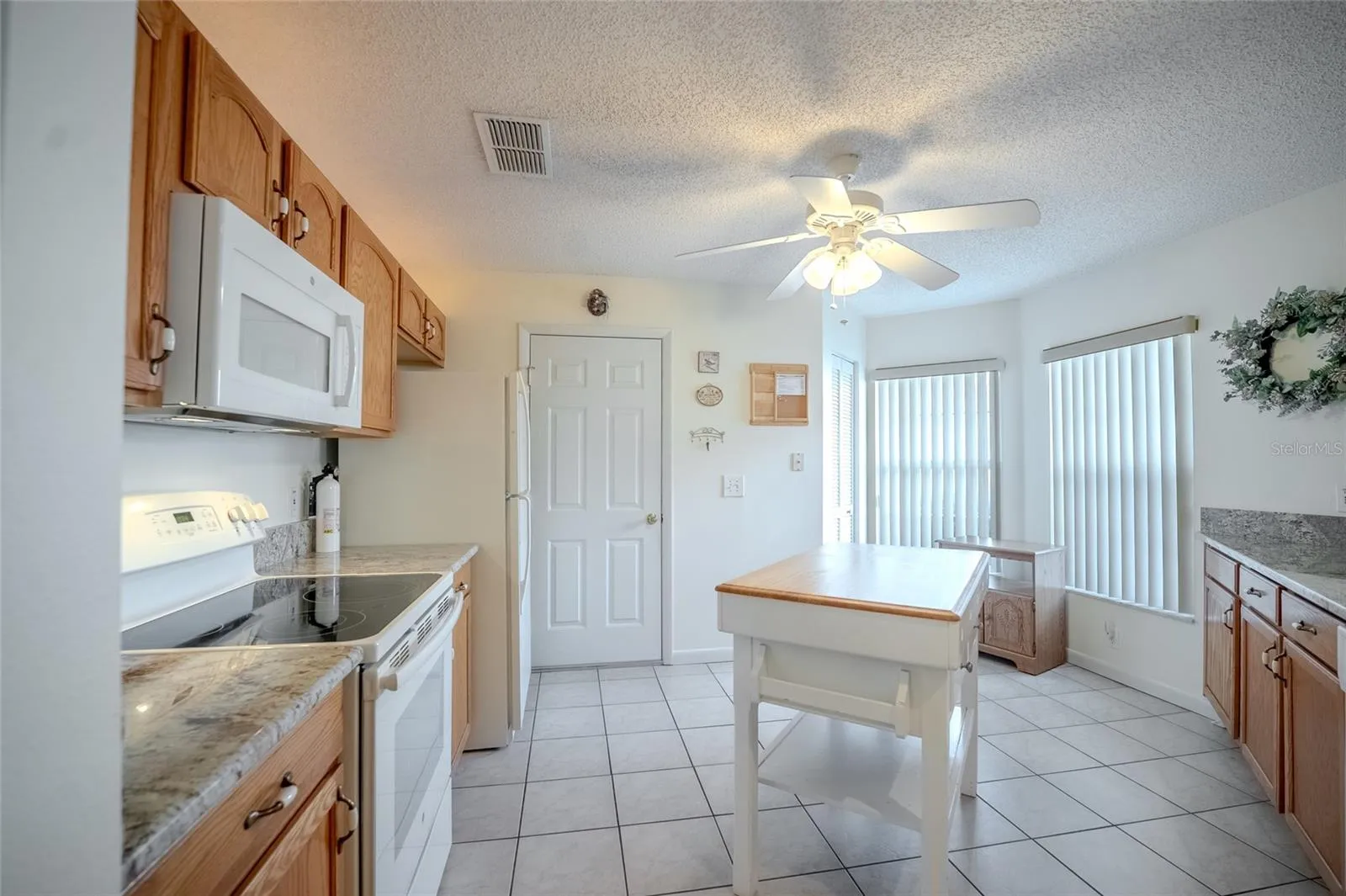 Kitchen with tile floor and eat-in area.