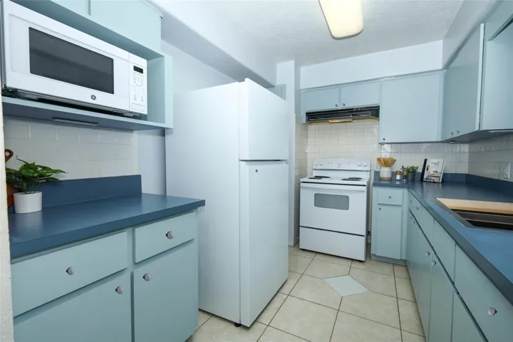 Kitchen with brand new black round knobs finished after photos