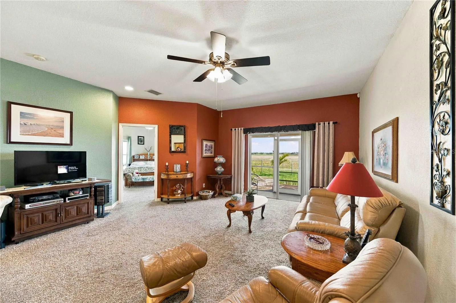 Spacious and comfortable living area featuring an open-concept layout with scenic views of the golf course.