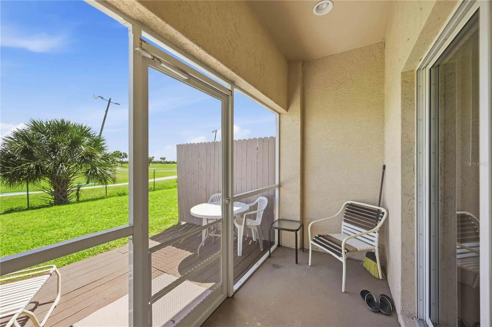 Spacious outdoor living area featuring a comfortable, covered lanai perfect for relaxing and entertaining.