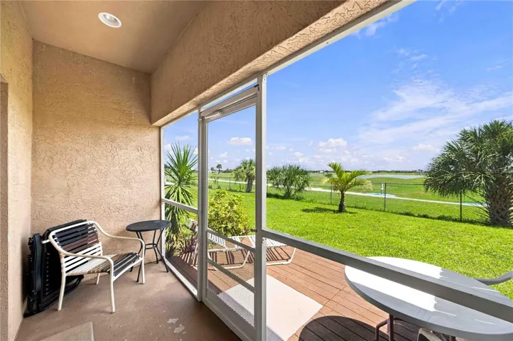 Experience breathtaking views featuring lush landscaping with bottle palms, sabal palms, and variegated arbicola set against a vibrant, well-manicured lawn.