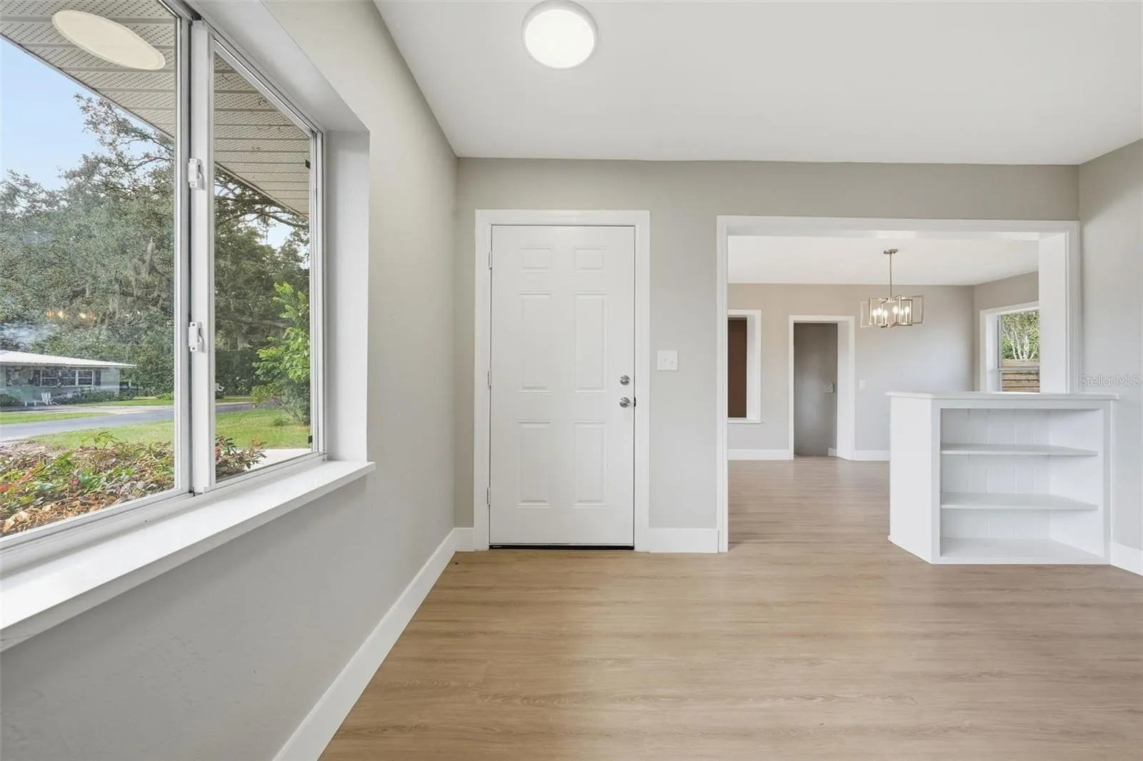 Front living room with LVP flooring, trim and baseboards